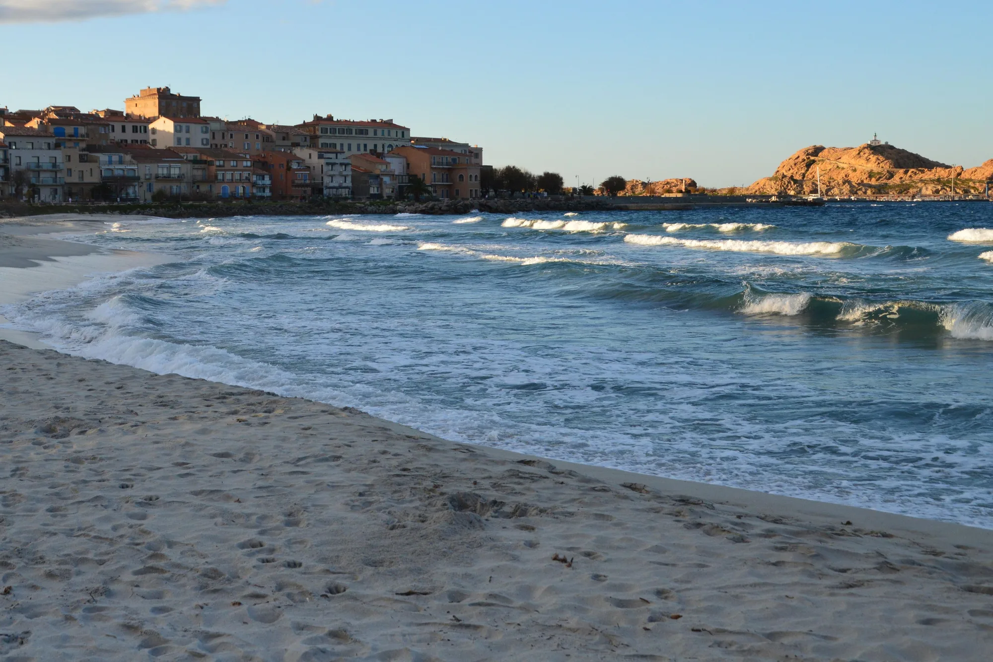 La plage de L’Île-Rousse au pied de la ville, l’île de la Pietra au fond